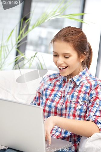 Image of happy woman with laptop computer