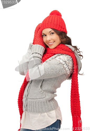 Image of beautiful woman in hat, muffler and mittens