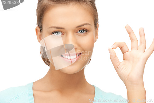 Image of lovely teenage girl showing ok sign