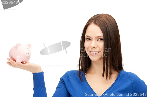 Image of lovely woman with piggy bank