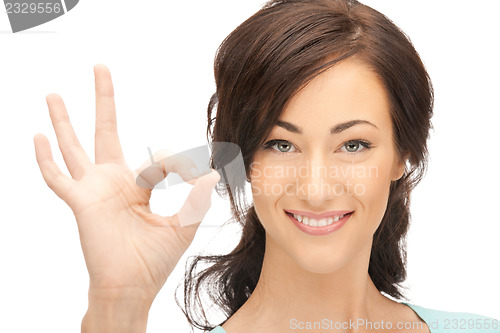 Image of lovely teenage girl showing ok sign