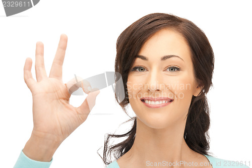 Image of lovely teenage girl showing ok sign
