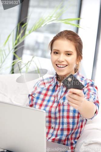 Image of happy woman with laptop computer and credit card