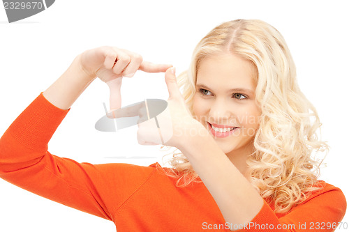 Image of lovely woman creating a frame with fingers