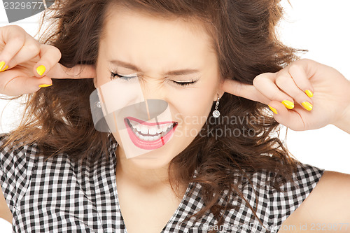 Image of woman with fingers in ears