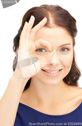 Image of lovely woman looking through hole from fingers