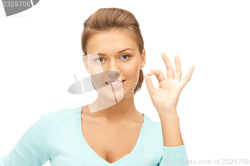 Image of lovely teenage girl showing ok sign