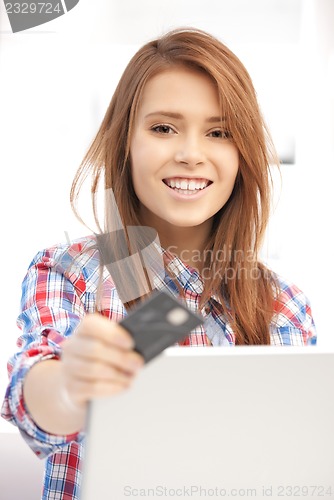 Image of happy woman with laptop computer and credit card