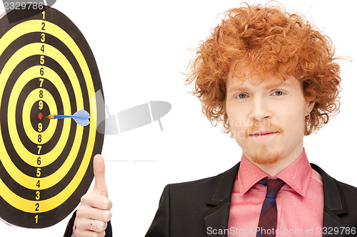 Image of businessman with dart and target