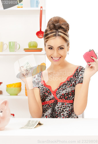 Image of beautiful housewife with purse and money