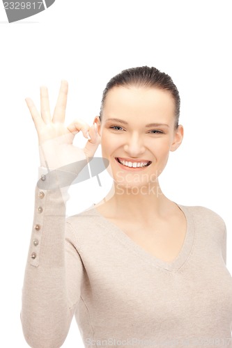 Image of lovely teenage girl showing ok sign
