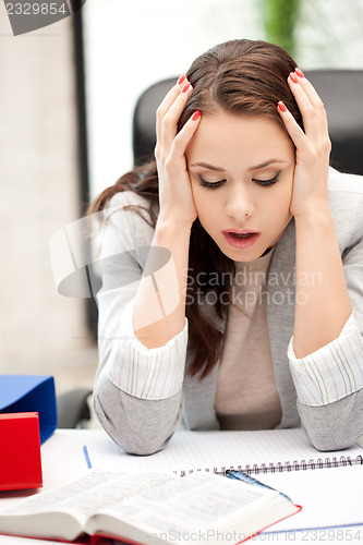 Image of worried woman with book