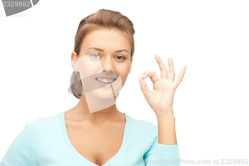 Image of lovely teenage girl showing ok sign
