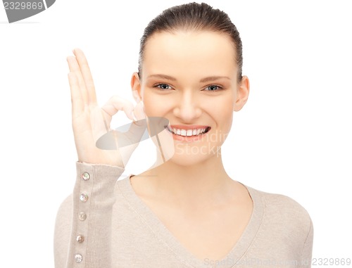 Image of lovely teenage girl showing ok sign