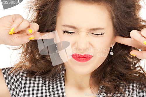 Image of woman with fingers in ears