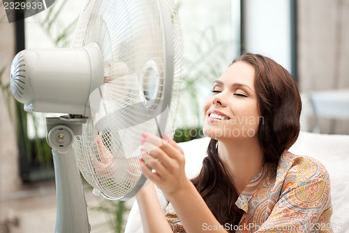 Image of happy woman with big fan