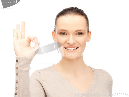 Image of lovely teenage girl showing ok sign