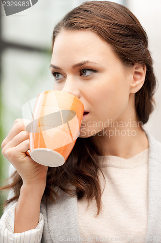 Image of lovely businesswoman with mug