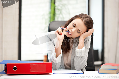 Image of pensive woman with big notepad