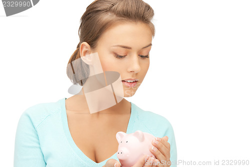 Image of lovely woman with piggy bank