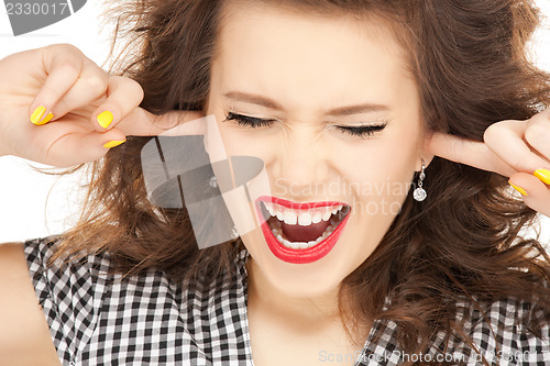 Image of woman with fingers in ears