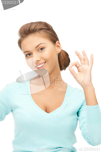 Image of lovely teenage girl showing ok sign