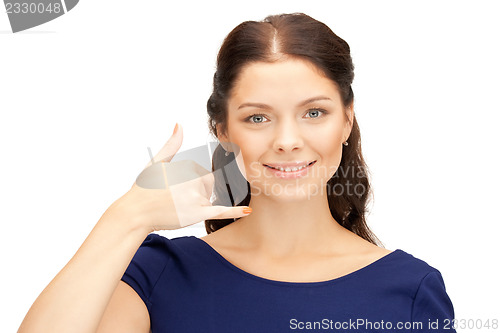 Image of woman making a call me gesture