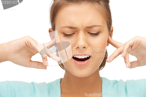 Image of woman with fingers in ears