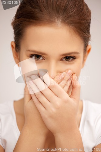 Image of woman with hand over mouth