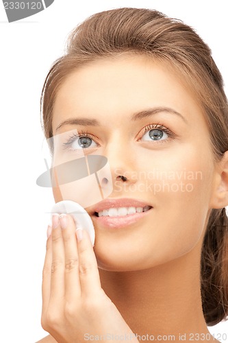 Image of beautiful woman with cotton pad