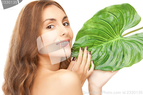 Image of woman with green leaf