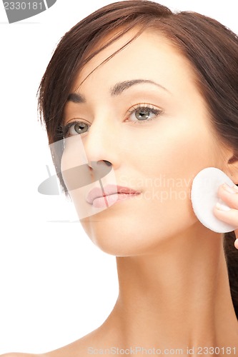 Image of beautiful woman with cotton pad