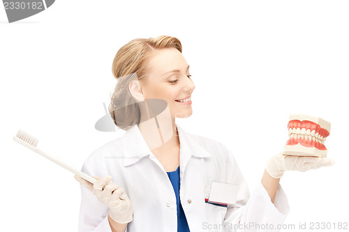 Image of doctor with toothbrush and jaws