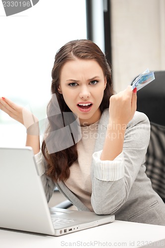 Image of unhappy woman with computer and euro cash money