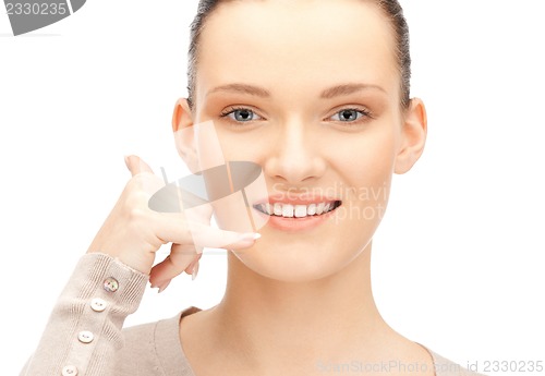 Image of woman making a call me gesture