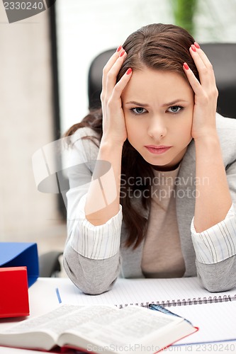 Image of worried woman with book