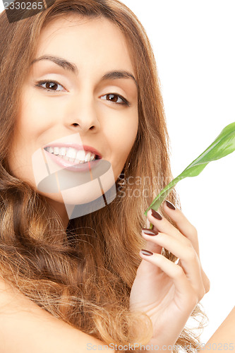 Image of woman with green leaf