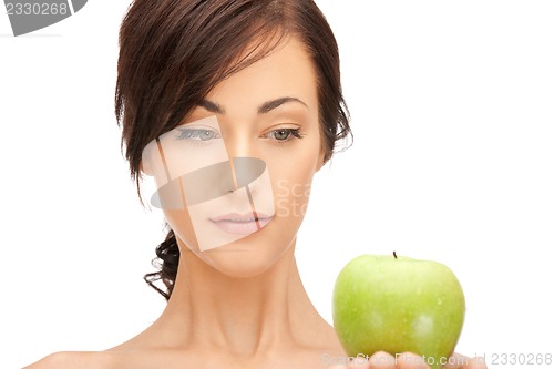 Image of young beautiful woman with green apple