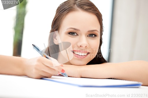 Image of happy woman with big notepad