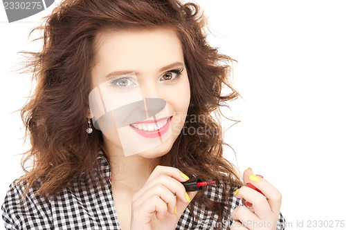 Image of beautiful woman polishing her nails