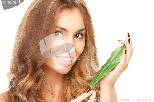 Image of woman with green leaf