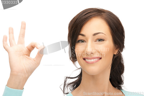 Image of lovely teenage girl showing ok sign