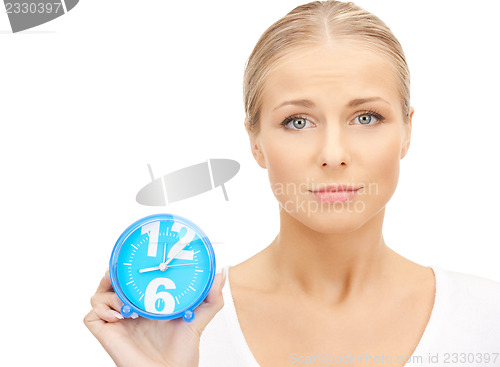 Image of woman holding alarm clock