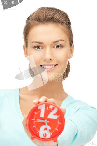 Image of woman holding alarm clock