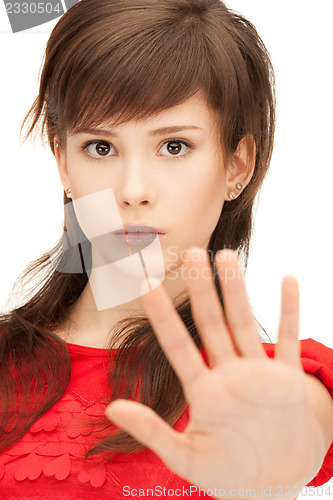 Image of teenage girl making stop gesture