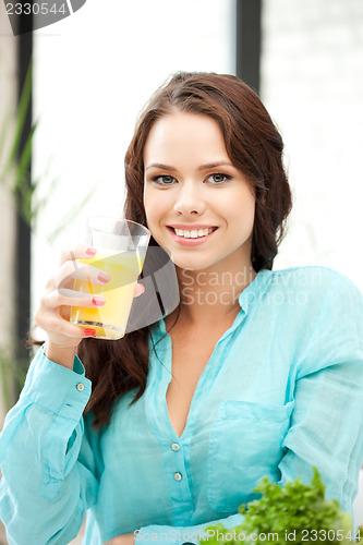 Image of beautiful woman with glass of juice