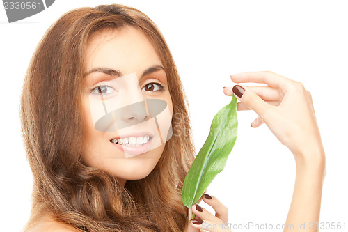 Image of woman with green leaf