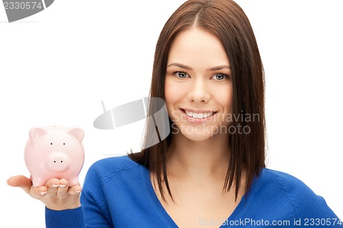 Image of lovely woman with piggy bank