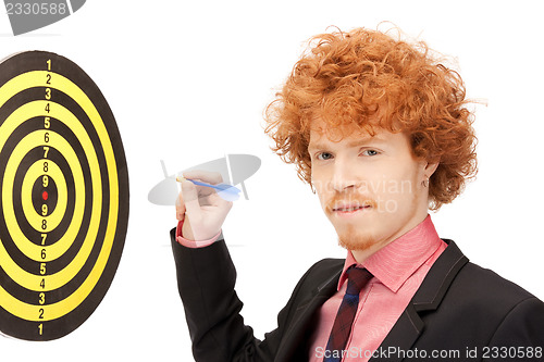 Image of businessman with dart and target