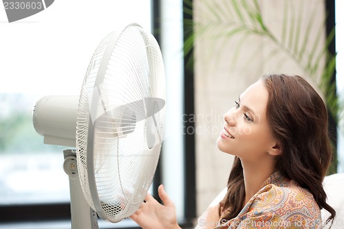 Image of happy woman with big fan